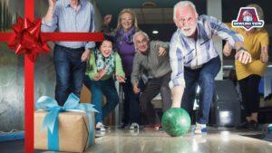 Senior bowlers celebrating at a bowling alley with gifts, perfect for best gifts for bowlers article